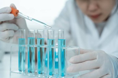 Scientist analyze biochemical samples in advanced scientific laboratory. Medical professional use dropper mix microbiological developmental of viral. Biotechnology research in  science lab. cosmetic