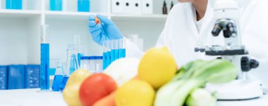 Scientist check chemical food residues in laboratory. Control experts inspect quality of fruits, vegetables. lab, hazards, ROHs, find prohibited substances, contaminate, Microscope, Microbiologist