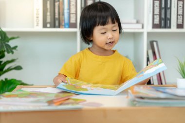 Mutlu Asyalı çocuklar evde kitap okuyarak rahatlar. Kızım ve bir hikaye okuyordum. öğrenme, çocuk bakımı, gülme, eğitim, hikaye anlatma, uygulama, hayal etme, bağımlılık cep telefonunu azaltma