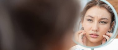 Young woman are worried about faces Dermatology and allergic to steroids in cosmetics. sensitive skin, red face from sunburn, acne, allergic to chemicals, rash on face. skin problems and beauty