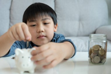 Save money. children putting coin for saving. wealth, Finance, insurance, investment, education, future, plan life, learn, banking, family, health, health and accident insurance