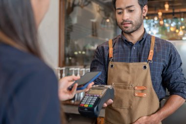 Woman use smartphone to scan QR code to pay in cafe restaurant with a digital payment without cash. Choose menu and order accumulate discount. E wallet, technology, pay online, credit card, bank app.