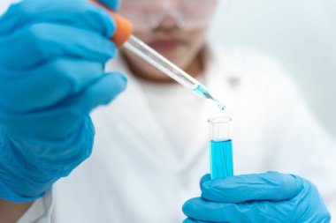 Scientist analyze biochemical samples in advanced scientific laboratory. Medical professional use dropper mix microbiological developmental of viral. Biotechnology research in  science lab. cosmetic