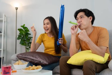 Asian young fun exultant happy fan man cheer up support sport team. crazy and happy male, man raising 2 hands very happy winner of sport, cheerful, cheer up, cheer leader, success, celebrate, fan club