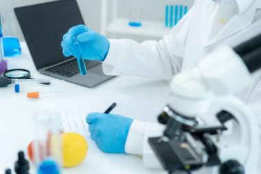 Scientist check chemical food residues in laboratory. Control experts inspect quality of fruits, vegetables. lab, hazards, ROHs, find prohibited substances, contaminate, Microscope, Microbiologist