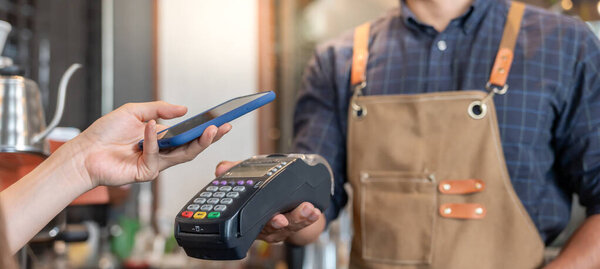 Happy Owner receive scan QR code to pay in cafe restaurant with a digital payment without cash. Choose menu and order accumulate discount. E wallet, technology, pay online, credit card, bank app