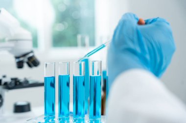 Scientist analyze biochemical samples in advanced scientific laboratory. Medical professional use dropper mix microbiological developmental of viral. Biotechnology research in  science lab. cosmetic