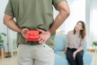 Mutlu koca sürpriz eş için hediye kutusu arar ve saklar. Sevimli kız, heyecanlı hediye kutusu. Doğum günü, kutlama, xmas, yeni yıl festivali, teşekkür, kutlama, sevgililer günü, evlilik yıldönümü 