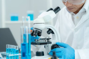 Scientist check chemical food residues in laboratory. Control experts inspect quality of fruits, vegetables. lab, hazards, ROHs, find prohibited substances, contaminate, Microscope, Microbiologist