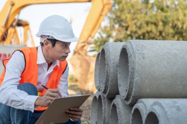 inspector or engineer is inspecting construction house using a checklist. Engineers and architects or contactor count materials for construction. Building, check, insurance house, quality, foreman.