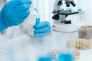 Scientist analyze biochemical samples in advanced scientific laboratory. Medical professional use dropper mix microbiological developmental of viral. Biotechnology research in  science lab. cosmetic