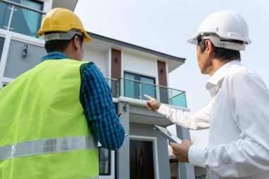 inspector engineer and owner project is inspecting construction and quality assurance new house. Engineers or architects or contactor work to build the house before handing it over to the homeowner