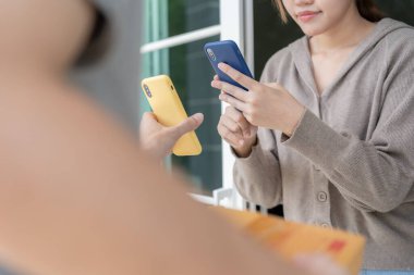 Happy smile Asian woman scan QR code for pay of food. Delivery man send deliver express. online shop, paper container, takeaway, postman, delivery service, packages, electronic money, Digital transfe