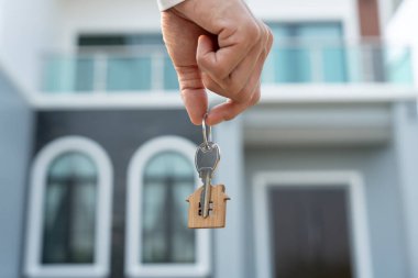 Kira, kiralama ve ev satma. Emlakçının elinde yeni bir ev ya da emlak için anahtar var. kira, satış, kredi finans, sigorta, satıcı, dağıtıcı, taksit, satın alma, satma, taşınma