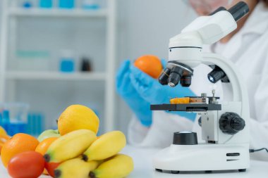 Scientist check chemical food residues in laboratory. Control experts inspect quality of fruits, vegetables. lab, hazards, ROHs, find prohibited substances, contaminate, Microscope, Microbiologist