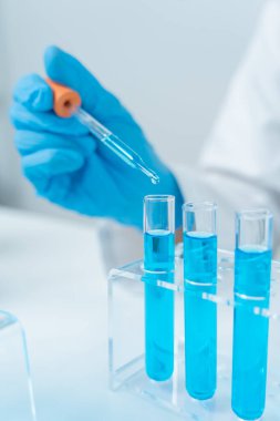 Scientist analyze biochemical samples in advanced scientific laboratory. Medical professional use dropper mix microbiological developmental of viral. Biotechnology research in  science lab. cosmetic