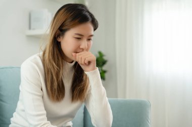 sick woman with a headache sitting under blanket, female sneezing and runny nose with seasonal influenza, allergic, high fever and influenza, resting, virus, coronavirus, feel illness, respiratory