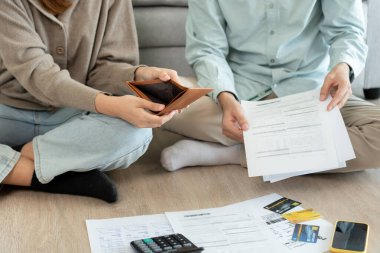 Stressed and headache asian couple with large bills or invoices no money to pay to expenses and business problem. shortage, Financial problems, mortgage, loan, bankruptcy, bankrupt, poor