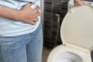 Constipation and diarrhea in bathroom. Hurt woman touch belly  stomach ache painful. colon inflammation problem, toxic food, abdominal pain, abdomen, constipated in toilet, stomachache, Hygiene