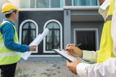 inspector engineer and owner project is inspecting construction and quality assurance new house. Engineers or architects or contactor work to build the house before handing it over to the homeowner