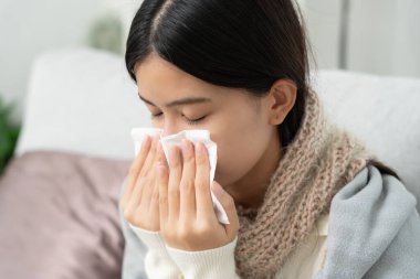 sick woman with a headache sitting under blanket, female sneezing and runny nose with seasonal influenza, allergic, high fever and influenza, resting, virus, coronavirus, feel illness, respiratory