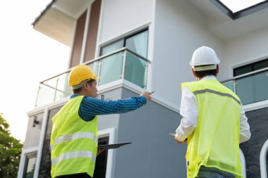 inspector engineer and owner project is inspecting construction and quality assurance new house. Engineers or architects or contactor work to build the house before handing it over to the homeowner
