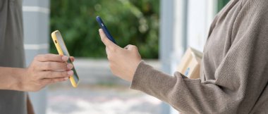 Happy smile Asian woman scan QR code for pay of food. Delivery man send deliver express. online shop, paper container, takeaway, postman, delivery service, packages, electronic money, Digital transfe