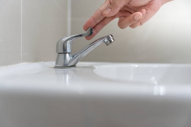 Save water. Volunteer keeps turning off the running water in the bathroom to protect environment. Greening planet, reduce global warming, Save world, life, future, risk energy, crisis , water day.