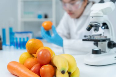 Scientist check chemical food residues in laboratory. Control experts inspect quality of fruits, vegetables. lab, hazards, ROHs, find prohibited substances, contaminate, Microscope, Microbiologist