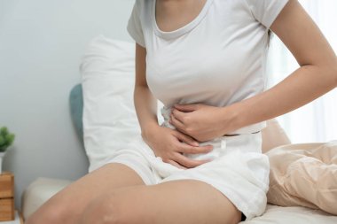 stomach ache. Asian women have abdominal pain, indigestion, gastritis, menstrual cramps, flatulence, diarrhea, distention, colon cancer, belly inflammation problem, suffer food poisoning, abdomen