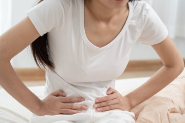 stomach ache. Asian women have abdominal pain, indigestion, gastritis, menstrual cramps, flatulence, diarrhea, distention, colon cancer, belly inflammation problem, suffer food poisoning, abdome