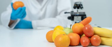 Scientist check chemical food residues in laboratory. Control experts inspect quality of fruits, vegetables. lab, hazards, ROHs, find prohibited substances, contaminate, Microscope, Microbiologist