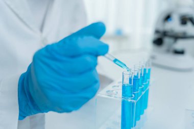 Scientist analyze biochemical samples in advanced scientific laboratory. Medical professional use dropper mix microbiological developmental of viral. Biotechnology research in  science lab. cosmetic