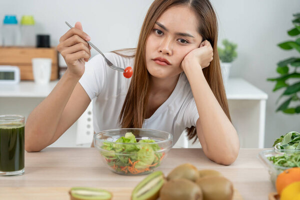 slim body asian women very bored diet food, dieting female choose low calories food for diet. Good healthy food. weight lose, balance, control, reduce fat, routines, exercise, body shap