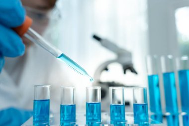 Scientist analyze biochemical samples in advanced scientific laboratory. Medical professional use dropper mix microbiological developmental of viral. Biotechnology research in  science lab. cosmetic