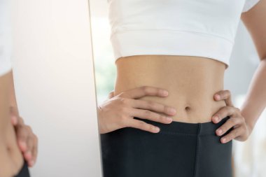 Diyet yapan kadınlar. Güzel şekil. Kadın vücudu için aynaya bakıyor. Kilo verdikten sonra bel ölçüleri küçülmüş. denge, kontrol, rutinler, egzersiz.