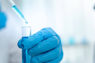 Scientist analyze biochemical samples in advanced scientific laboratory. Medical professional use dropper mix microbiological developmental of viral. Biotechnology research in  science lab. cosmetic