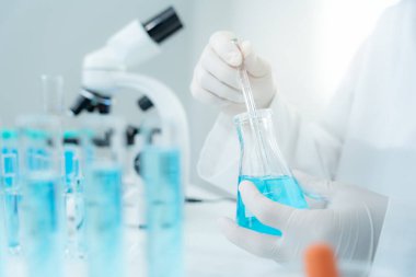 Scientist analyze biochemical samples in advanced scientific laboratory. Medical are mixing chemicals to test physical properties of cosmetic. develop viral. Biotechnology research in science lab.