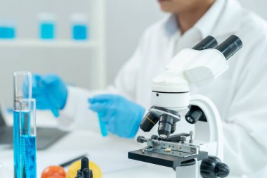 Scientist check chemical food residues in laboratory. Control experts inspect quality of fruits, vegetables. lab, hazards, ROHs, find prohibited substances, contaminate, Microscope, Microbiologist
