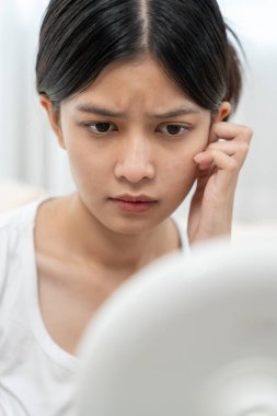 Young woman are worried about faces Dermatology and allergic to steroids in cosmetics. sensitive skin, red face from sunburn, acne, allergic to chemicals, rash on face. skin problems and beauty