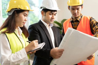 Engineers team discuss check and review the blueprint of construction. Contractor inspection drawing before start project civil. project planning, consulting, 