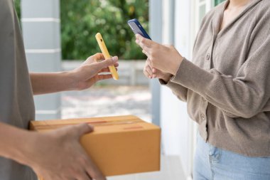 Happy Asian woman scan QR code for pay goods delivery. Delivery man send deliver express. online shop, paper container, takeaway, postman, delivery service, packages, electronic money, Digital transfe