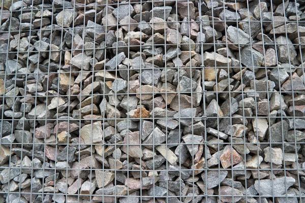 stock image Natural stone wall with stones and metal framework