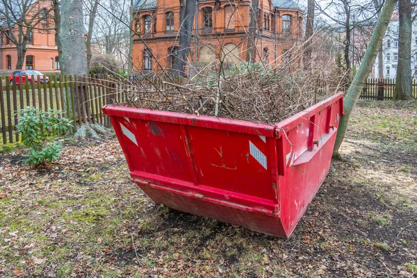 Container with garden waste in autumn