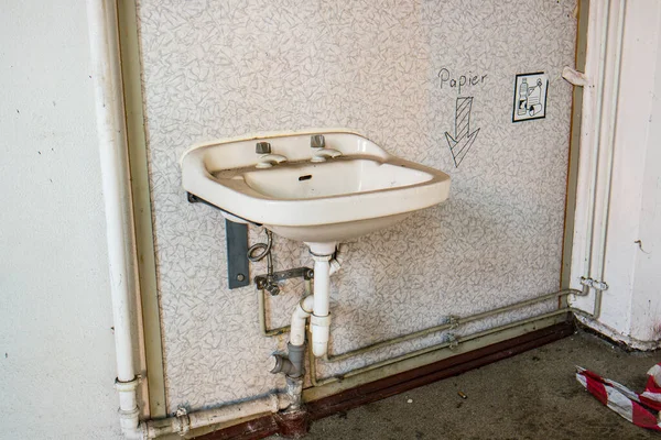 Old dilapidated sink in a factory