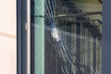 Burglary with broken glass on a window clipart