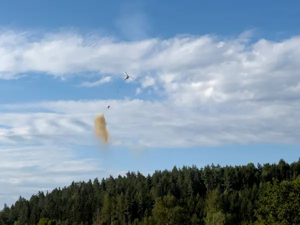 stock image Forest liming with a helicopter against the bark beetle and pest control