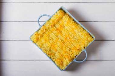 Creamy fish pie or fisherman's pie - traditional British and Irish dish. View from above, top studio shot  clipart