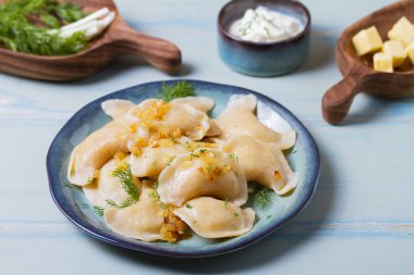 Dumplings filled with mashed potatoes. Varenyky, vareniki, pierogi, pyrohy - dumplings with filling clipart