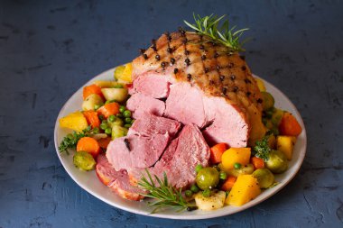 Clove baked ham with potatoes, carrots, turnip and brussel sprouts clipart